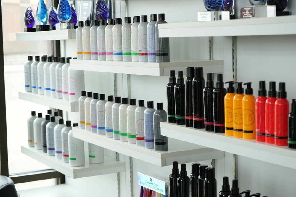 Retail shelf of salon products at a backbar
